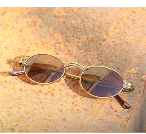 Detail of vintage steampunk sunglasses with gold metal frame and tea lenses on a rusty plate