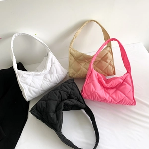 Detailed view of quilted nylon pillow bags in white, black, pink and khaki colors