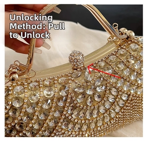 Detail of the lifting lock mechanism on a luxury golden dinner bag with shiny rhinestones