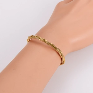 Gold multi-layered twisted rope snake bracelet with punk hip hop style on model hand