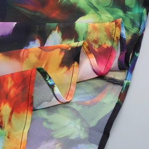 Detail view of colorful floral print fabric showing high-quality stitching and drape
