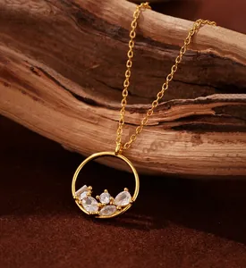 Detail of gold pendant necklace with mixed-cut zircons on natural wood background