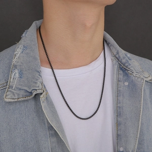 Black 3mm stainless steel dragon bone chain shown on a model wearing a denim jacket