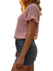 Detail of pink hollow knit top with ruffled short sleeves and textured fabric