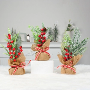 Set of three mini Christmas pine trees with red berries and burlap bases for table decor
