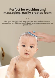 Adult hand holding a soft blue silicone baby hair brush massaging infant scalp in bathroom