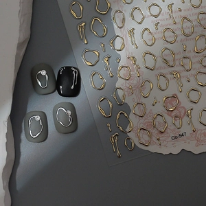 Detailed view of 3D liquid metal nail stickers with irregular gold and silver relief patterns