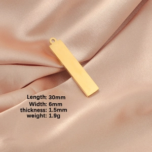 Polished gold rectangular pendant 30x6mm on pink satin with product measurements