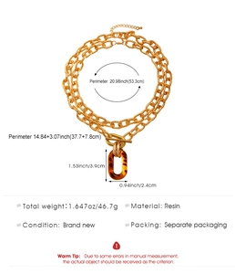 Detail view of gold chunky double-layer necklace with leopard resin pendant and OT clasp