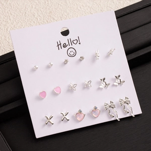 Detailed set of 9 pairs silver stud earrings featuring pink hearts and small pearls