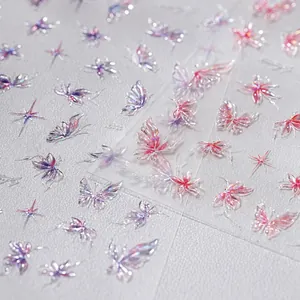 Detailed macro shot of holographic butterfly nail art stickers with glass shard effect.