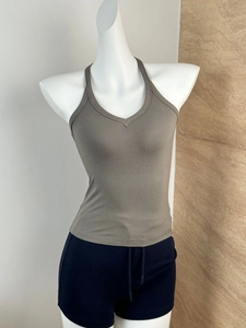 Detail of ribbed texture on gray-green deep V-neck tank top on mannequin display