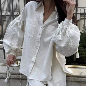 Women's white linen blend blouse with floral embroidery and tassel drawstring detail
