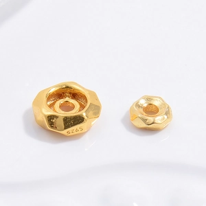 Macro detail of S925 sterling silver hexagonal spacer beads with polished gold plating