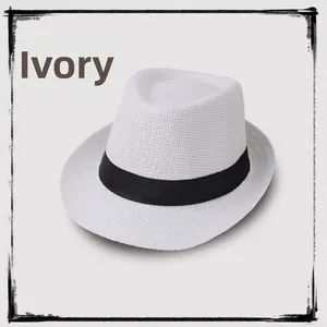 Close-up of cream white straw fedora hat featuring a wide black decorative ribbon band