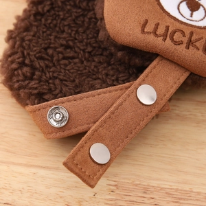 Detail of warm winter hat with lamb wool texture, metal snaps and bear logo embroidery