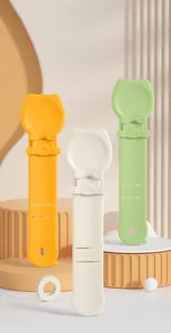 Three-color cat treat squeeze spoons in green, white, and yellow on a geometric stand
