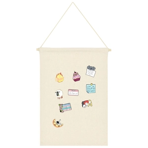 Detail of canvas banner organizer displaying various colorful cartoon enamel pins and badges