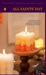 Macro detail of burning gradient orange skull cube candle with lit flame on music sheet