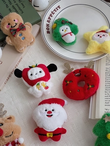 Detailed close-up of colorful plush Christmas ornaments and brooches on a holiday tray