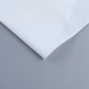 Close-up of white hollow-out long sleeve dress fabric showing stitch detail and texture