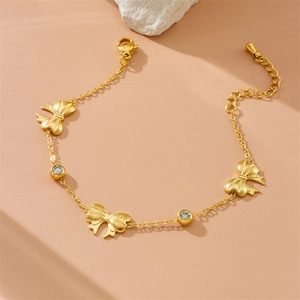 Elegant gold stainless steel bracelet featuring zircon stones and butterfly charms