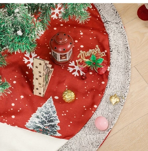Detail of red burlap Christmas tree skirt with plush white fleece border and snowflake prints