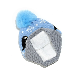 Detail of penguin jacquard winter hat with blue pom-pom and soft white fleece lining
