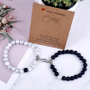 Detail of magnetic heart clasp on natural stone couple bracelets with gift card