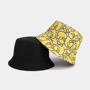 Detail of reversible sun bucket hat showing black side and yellow duck pattern print