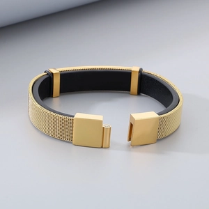 Close-up of golden mesh band bracelet with black lining and secure metal clasp