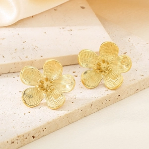 Macro view of gold-plated petal texture and core details of flower stud earrings