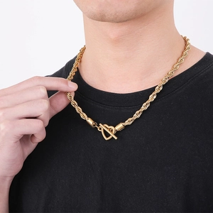 Close-up of a gold rope chain necklace with a stylish T-bar toggle clasp on a male model