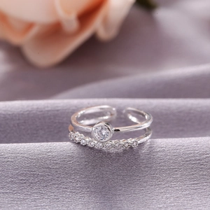 Detail of silver double-layered ring with a sparkling solitaire stone and pave accents