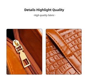 Detail of crocodile embossed leather tote with high quality golden metal zipper closure