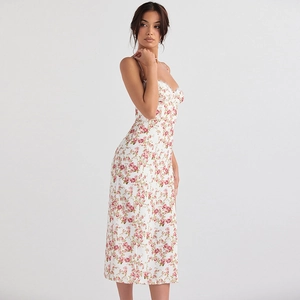 Side view of floral slip dress in white with red flower patterns and side slit detail