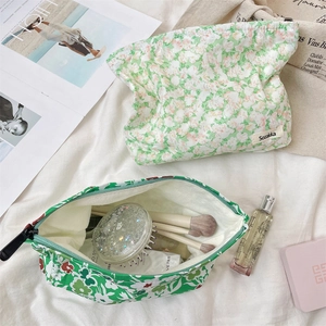 Close-up of a floral cotton makeup bag showing spacious interior with beauty accessories