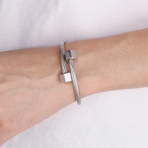 Detail of silver hex-end titanium steel cable bracelet featuring double twisted wire design