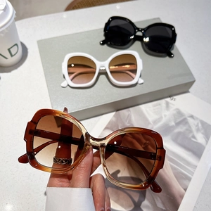 Chic oversized sunglasses with gradient lenses in black, amber, and white finishes
