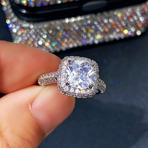 Macro shot of a luxury square-cut zircon ring with double halo and pave setting diamonds