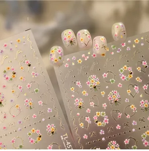Detailed macro view of 3D embossed floral nail stickers with gold heart accents
