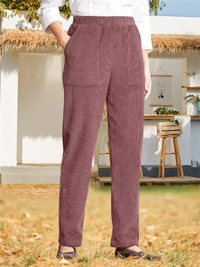 Detail of dusty pink corduroy pants showing elastic waist and large side pockets