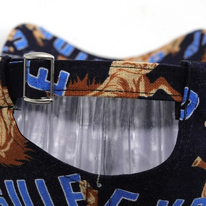 Detail of adjustable metal buckle and geometric pattern on the back of navy baseball cap