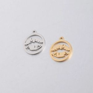 Macro view of gold and silver hollow lip pendants in polished stainless steel finish