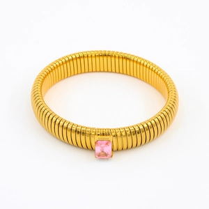 Detail of golden Tubogas snake bracelet featuring a rectangular pink zircon stone inlay