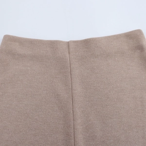 Macro shot of khaki knit skirt waistline showing premium fabric and seamless stitching