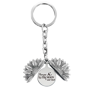 Macro view of sunflower locket keychain with I love you to the moon and back engraving