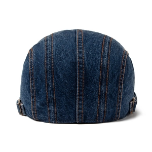 Deep blue denim beret for men and women with orange stitching on a white background