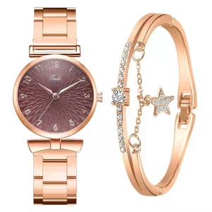 Close-up of rose gold watch and star pendant bracelet set on a white background