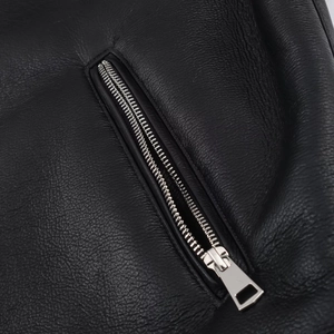 Close-up of premium black leather texture and sleek silver metal zipper on a jacket